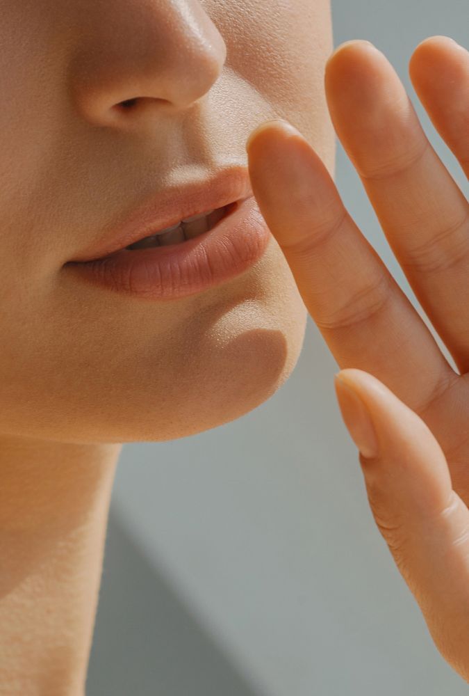 savannah injectables model with hand near lips